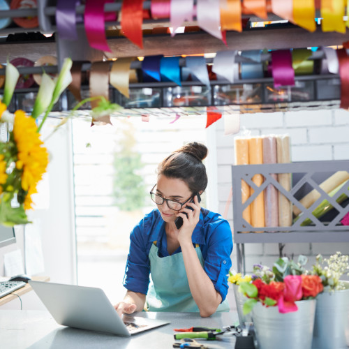 Florist small business owner placing order on the phone